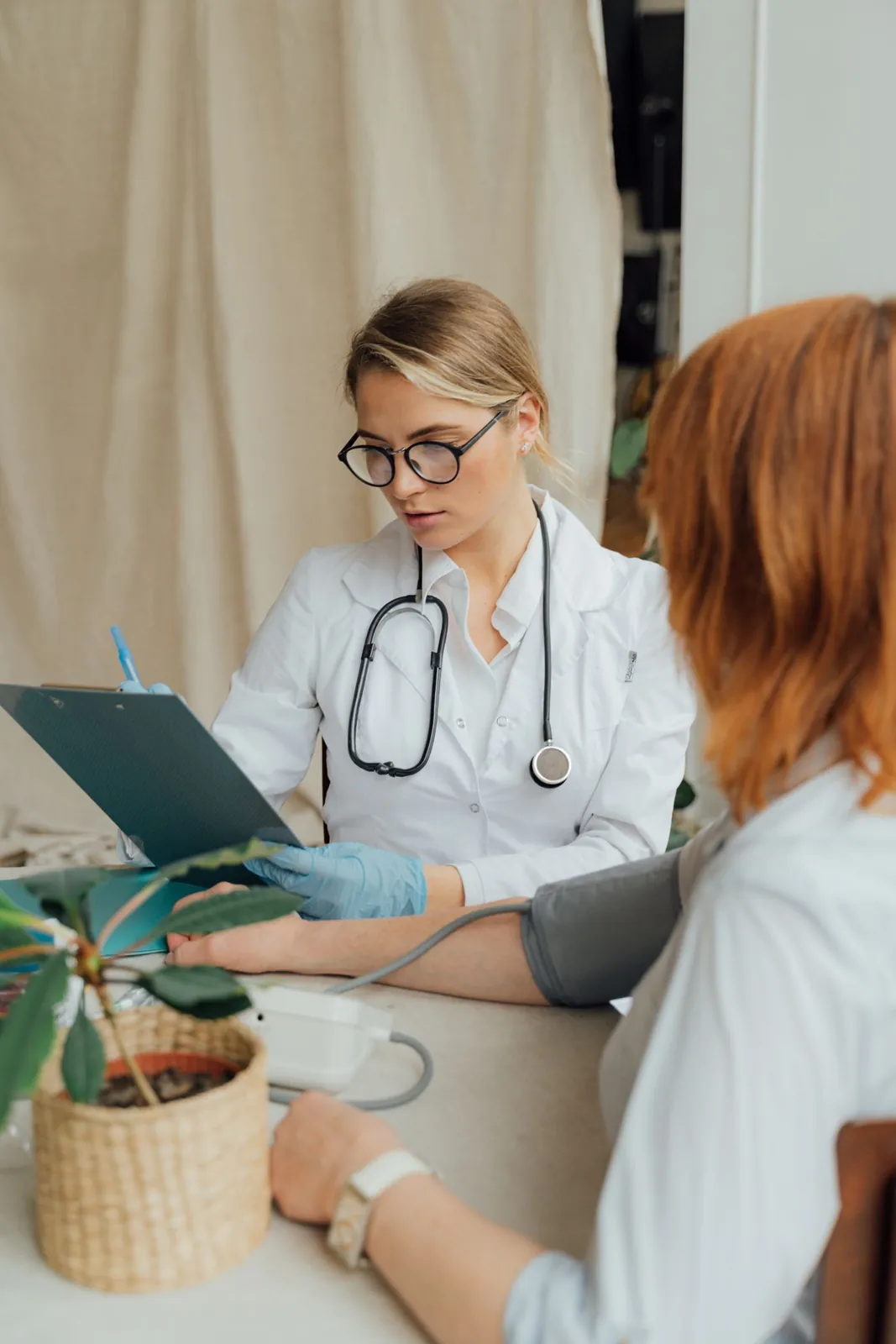 Une médecin prend la tension d’une patiente en consultation